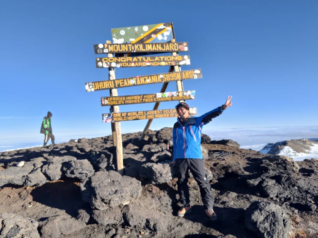 Climber Reaching Uhuru Peak Kilimanjaro Summit Triumph