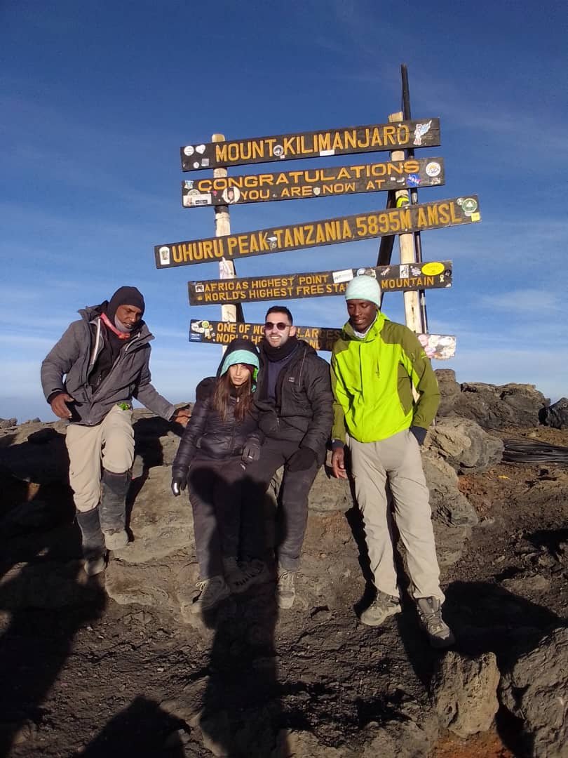Climbers And Guide At Uhuru Peak Summit Kilimanjaro