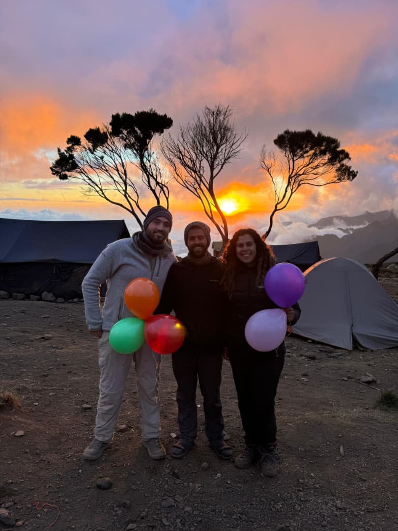 Friends Celebrating With Balloons At Kilimanjaro Sunrise Camp