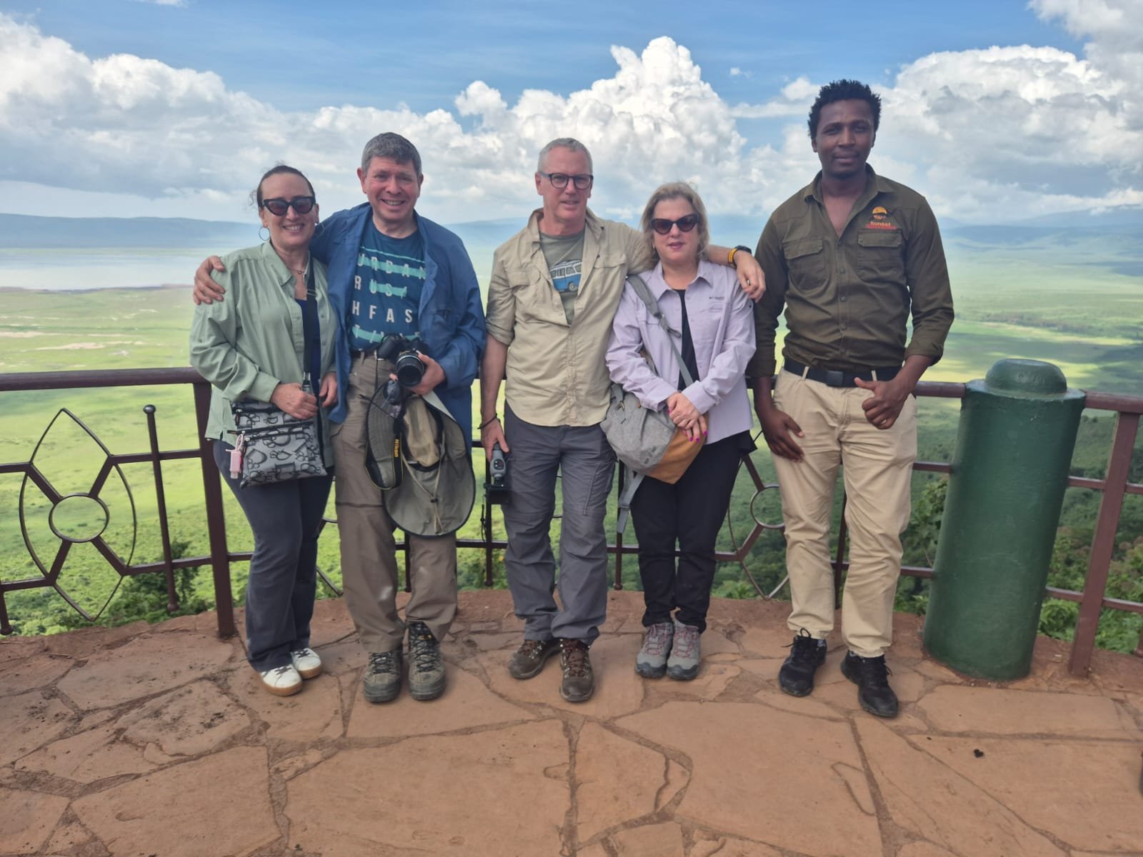 Sunset safari guide and travellers at the crater viewpoint