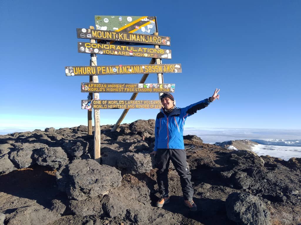 Triumphant Climber At Mount Kilimanjaro Uhuru Peak Summit