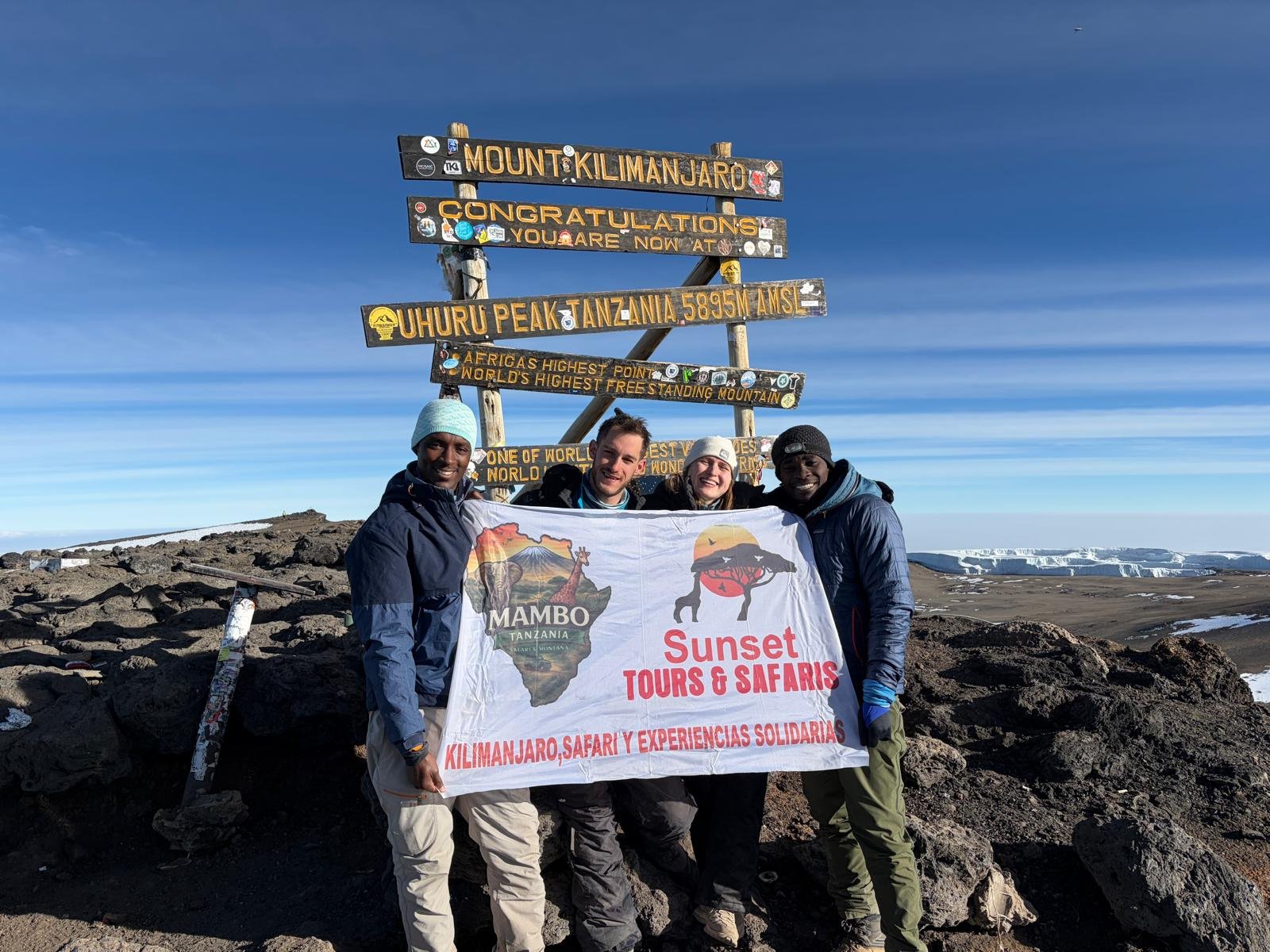 Sunset Tours climbers and guides at Uhuru Peak on Mount Kilimanjaro