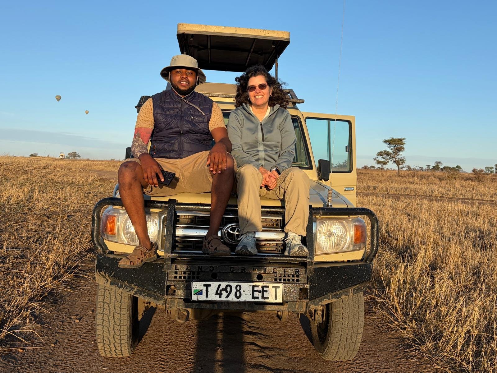 Travellers beside a safari vehicle; general safari photo