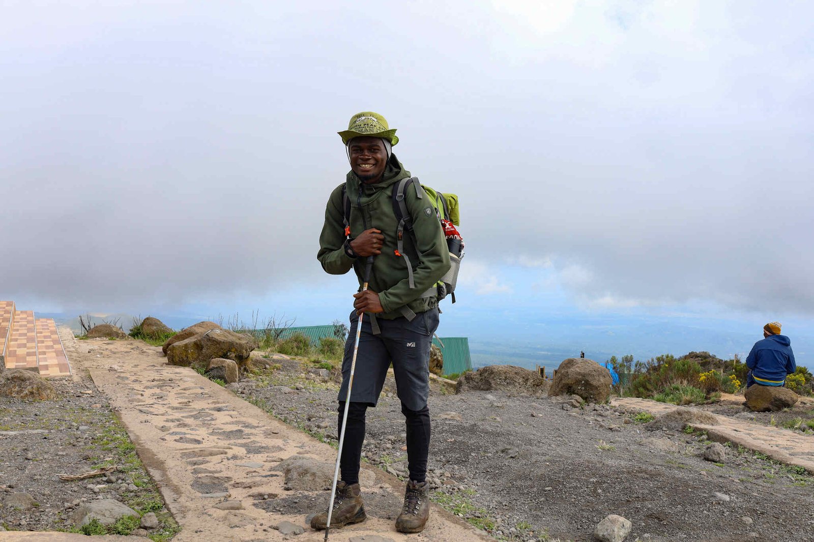 Local Sunset guide with trekking poles on Kilimanjaro
